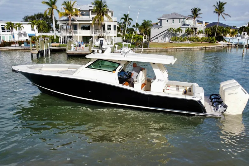  Yacht Photos Pics 2024 Scout 425 LXF boat cruising in a scenic waterfront setting.