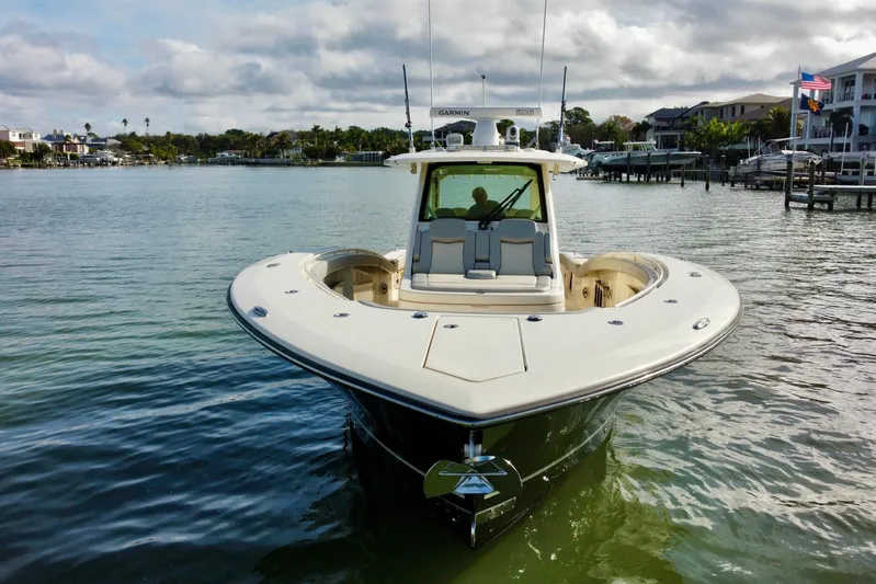  Yacht Photos Pics 2024 Scout 425 LXF boat on calm water, front view with clear sky.