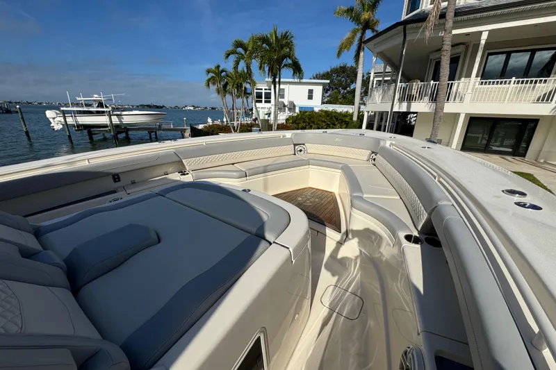  Yacht Photos Pics 2024 Scout 425 LXF luxury boat interior with plush seating and waterfront view.