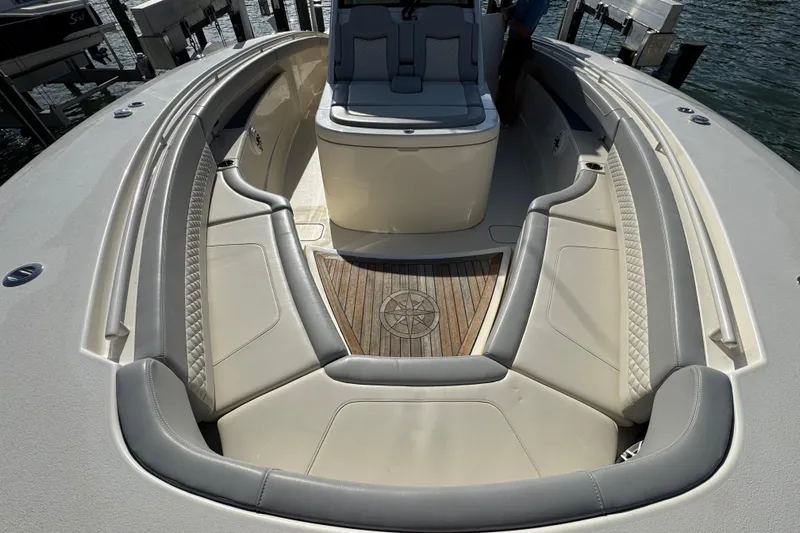  Yacht Photos Pics 2024 Scout 425 LXF boat interior with luxurious seating and wooden flooring.