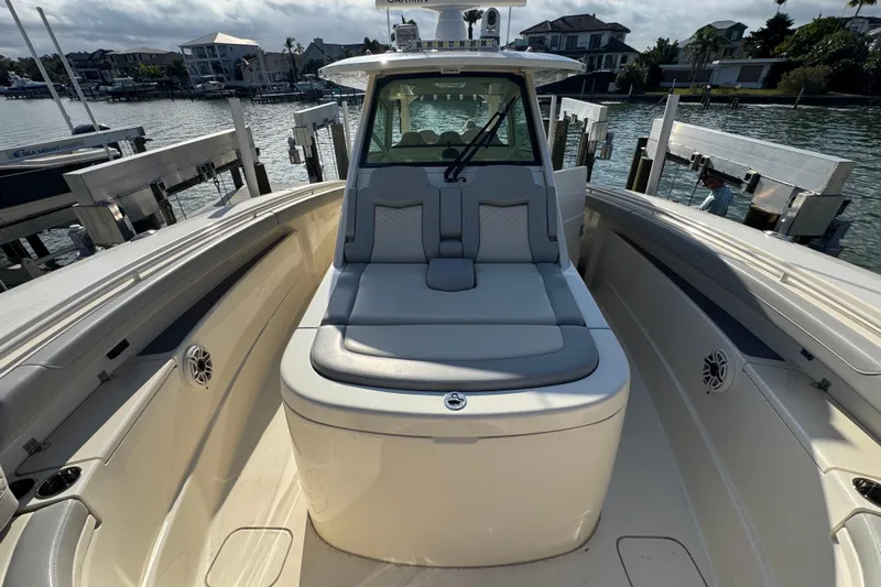  Yacht Photos Pics 2024 Scout 425 LXF boat interior with seating, docked by waterfront homes.