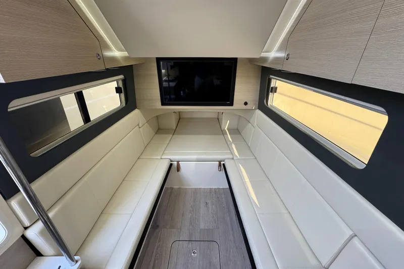  Yacht Photos Pics Luxurious interior of 2024 Scout 425 LXF boat with modern seating and TV.