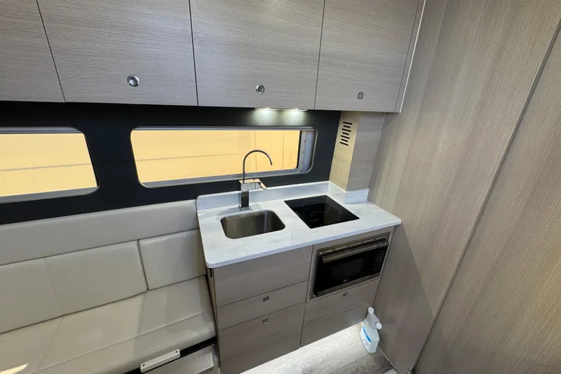  Yacht Photos Pics Modern kitchen interior of 2024 Scout 425 LXF with sleek cabinetry and appliances.