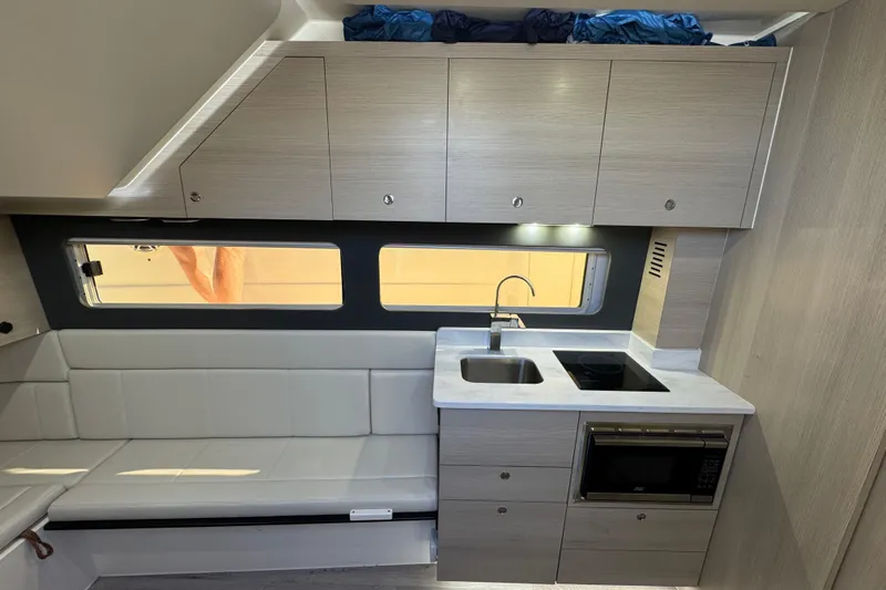  Yacht Photos Pics 2024 Scout 425 LXF interior with modern kitchen and seating area.