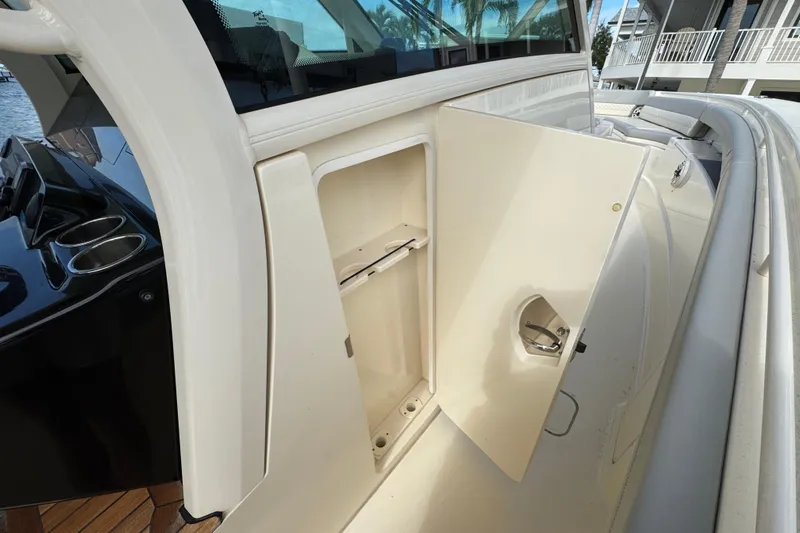  Yacht Photos Pics 2024 Scout 425 LXF boat storage compartment with open door, showcasing sleek design.