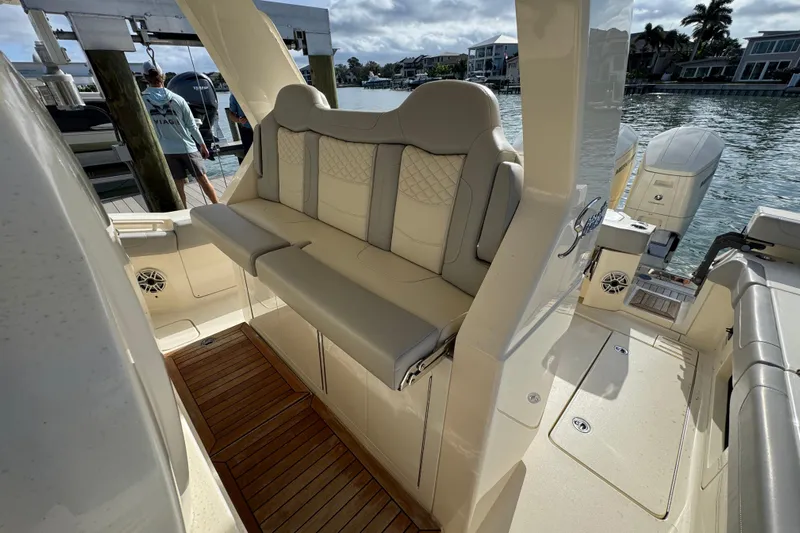  Yacht Photos Pics 2024 Scout 425 LXF boat interior with luxurious seating and wooden flooring.