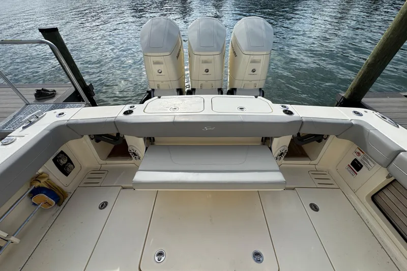  Yacht Photos Pics 2024 Scout 425 LXF boat with triple outboard engines at dock.