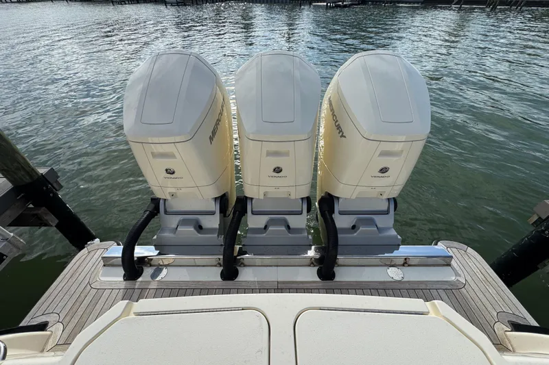  Yacht Photos Pics Triple Mercury Verado engines on 2024 Scout 425 LXF boat, docked by the water.