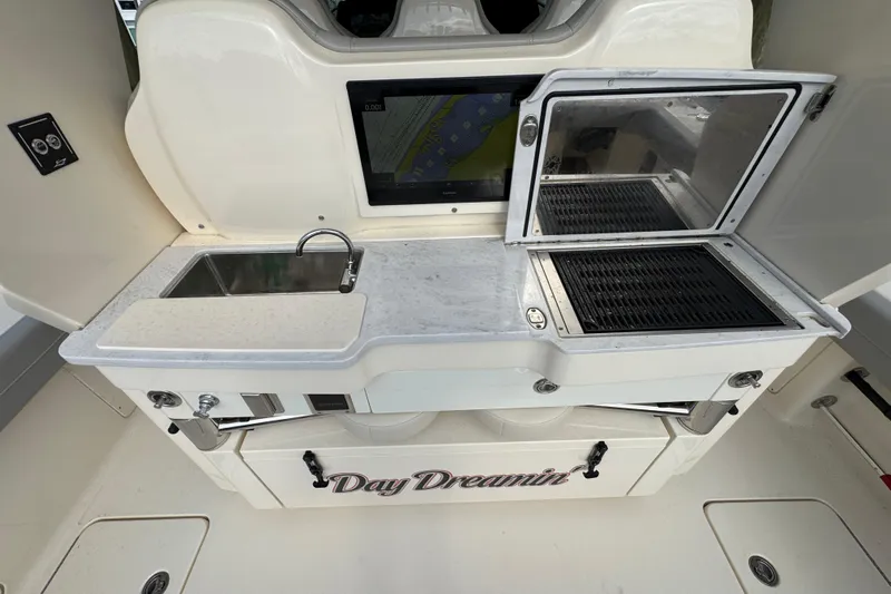  Yacht Photos Pics 2024 Scout 425 LXF boat kitchen with sink, grill, and storage labeled "Day Dreamin'."
