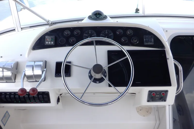 Epic Yacht Photos Pics 1998 Bayliner 4788 Pilot House Motoryacht helm with steering wheel and control panel.