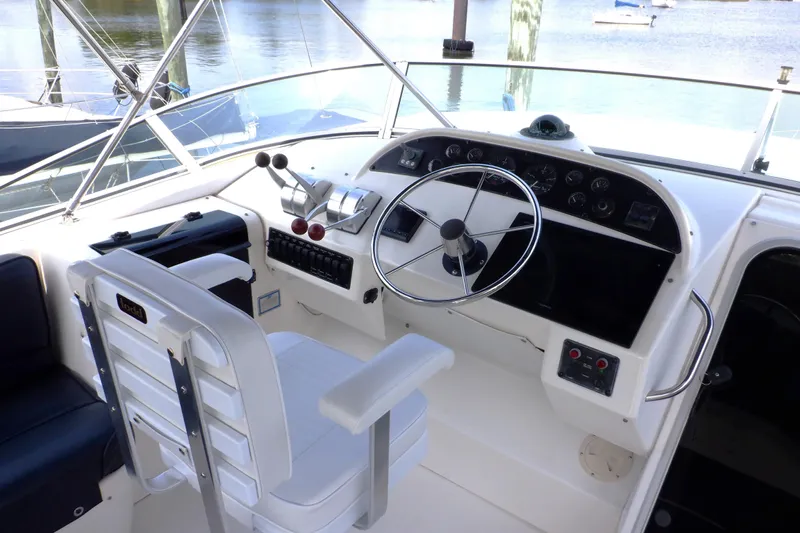 Epic Yacht Photos Pics 1998 Bayliner 4788 Pilot House Motoryacht helm with steering wheel and control panel.