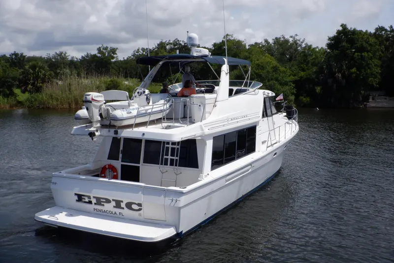 Epic Yacht Photos Pics 1998 Bayliner 4788 Pilot House Motoryacht cruising on a calm river.