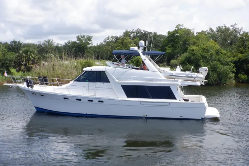 Epic Yacht Photos Pics 1998 Bayliner 4788 Pilot House Motoryacht cruising on a calm river.