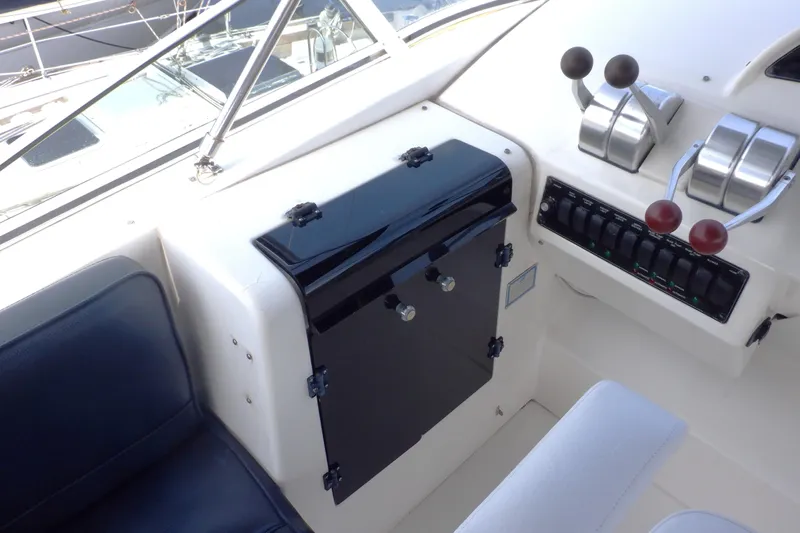 Epic Yacht Photos Pics 1998 Bayliner 4788 Pilot House Motoryacht helm with controls and seating.