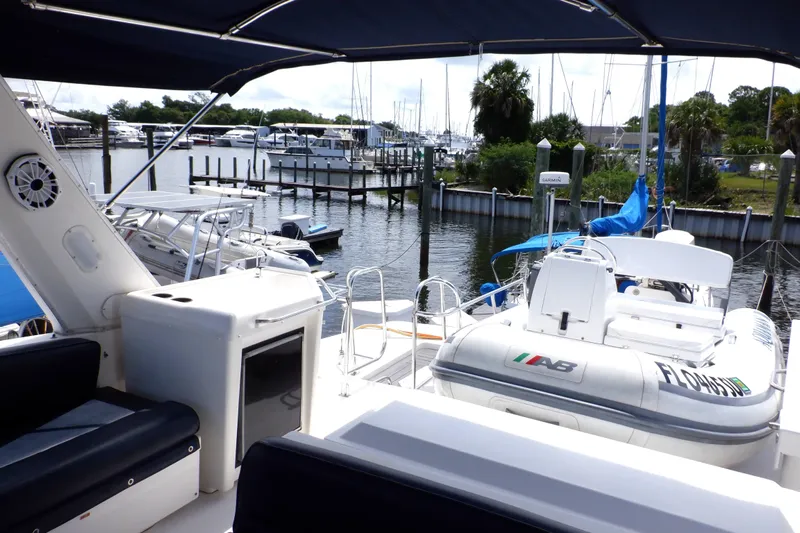 Epic Yacht Photos Pics 1998 Bayliner 4788 Pilot House Motoryacht docked at marina with inflatable boat.