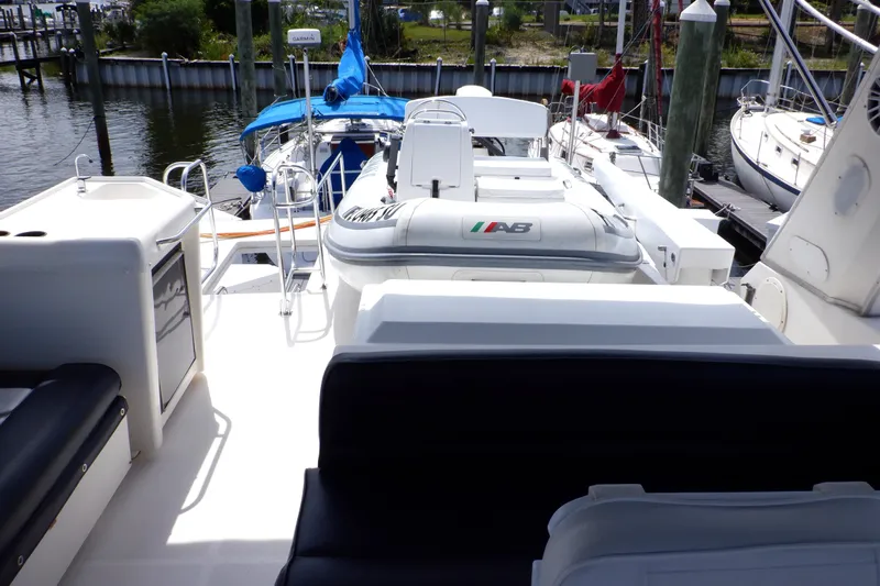 Epic Yacht Photos Pics 1998 Bayliner 4788 Pilot House Motoryacht deck with seating and inflatable boat.