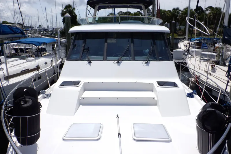 Epic Yacht Photos Pics 1998 Bayliner 4788 Pilot House Motoryacht docked at marina, surrounded by sailboats.