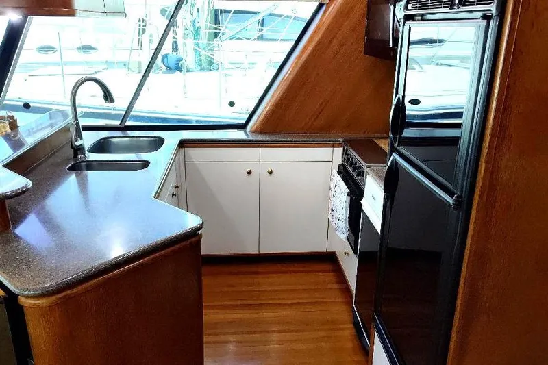 Epic Yacht Photos Pics Luxurious kitchen interior of 1998 Bayliner 4788 Pilot House Motoryacht with modern amenities.