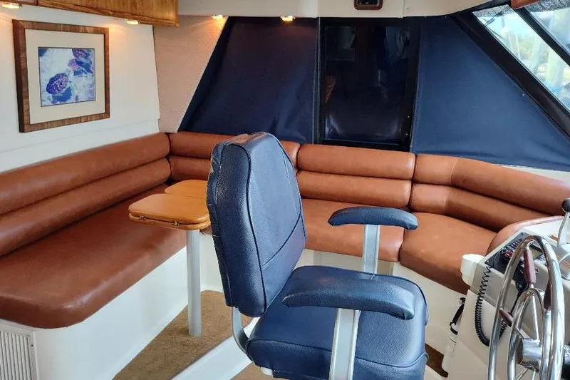 Epic Yacht Photos Pics 1998 Bayliner 4788 Pilot House Motoryacht interior with leather seating and helm chair.
