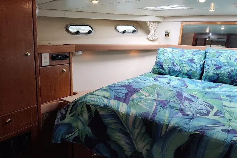 Epic Yacht Photos Pics Cozy bedroom in 1998 Bayliner 4788 Pilot House Motoryacht with tropical bedding.
