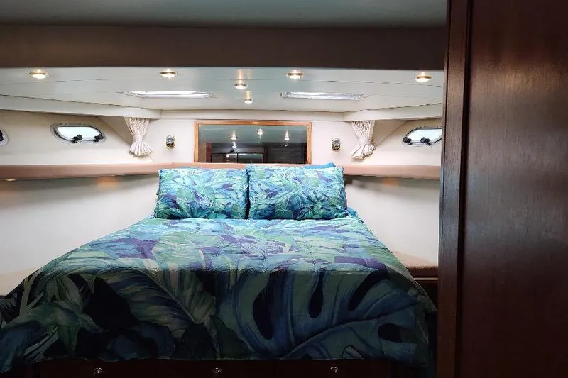 Epic Yacht Photos Pics Luxurious bedroom in 1998 Bayliner 4788 Pilot House Motoryacht with tropical bedding.