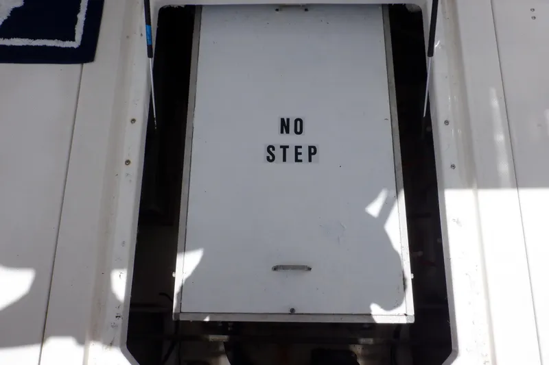 Epic Yacht Photos Pics Engine hatch with "No Step" sign on 1998 Bayliner 4788 Pilot House Motoryacht.