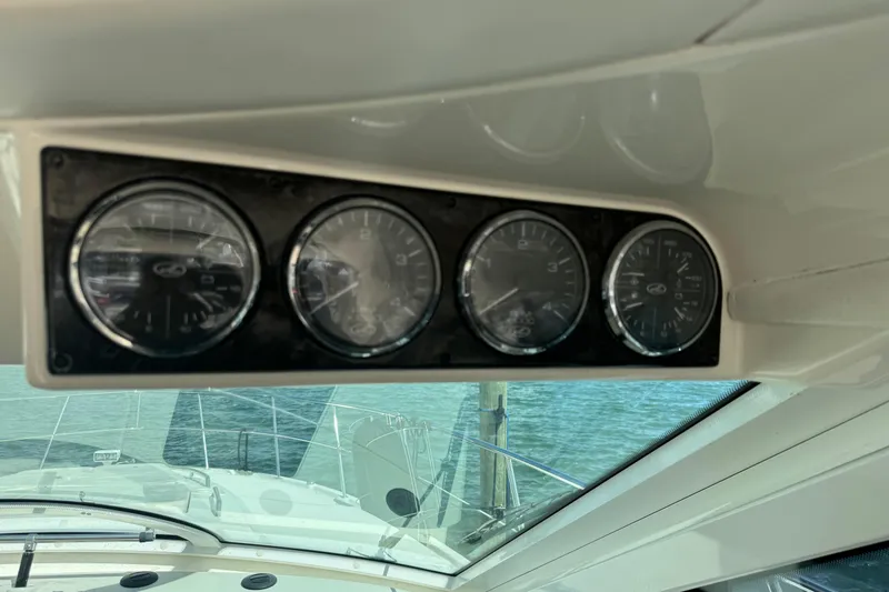 The Office Yacht Photos Pics Dashboard gauges on a 2011 Sea Ray 470 Sundancer yacht, overlooking the water.