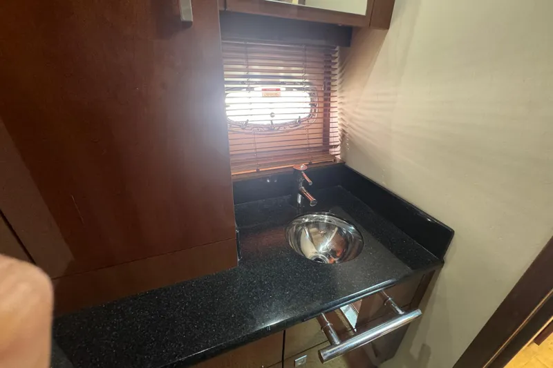 The Office Yacht Photos Pics Luxurious 2011 Sea Ray 470 Sundancer yacht interior with sleek sink and wooden cabinetry.