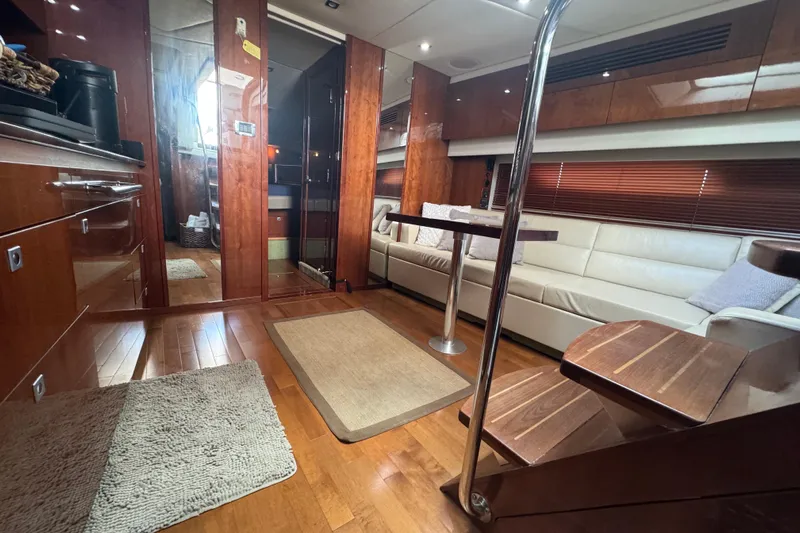 The Office Yacht Photos Pics Luxurious interior of 2011 Sea Ray 470 Sundancer yacht with wood finishes and modern seating.