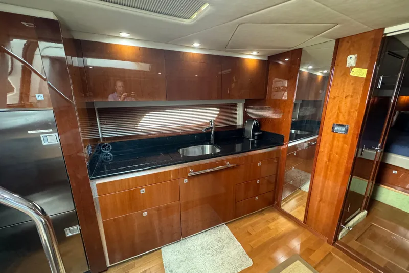 The Office Yacht Photos Pics Luxurious kitchen interior of 2011 Sea Ray 470 Sundancer yacht with wood cabinetry.
