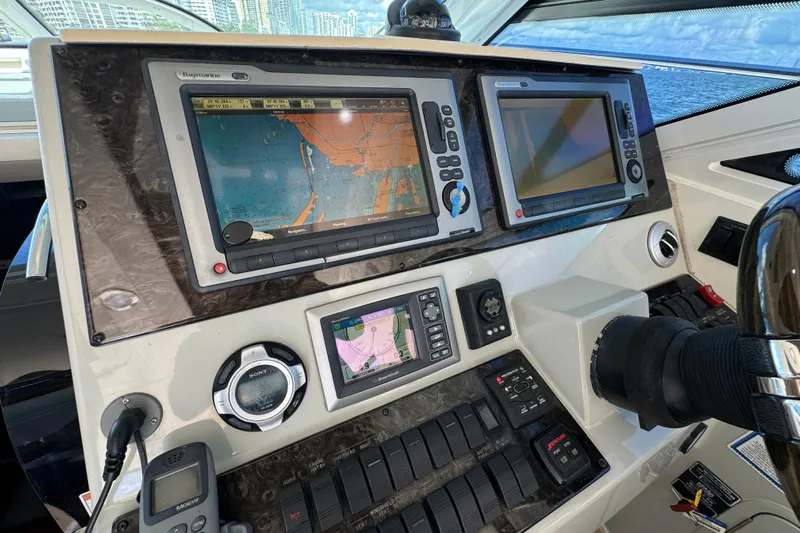 The Office Yacht Photos Pics Control panel of a 2011 Sea Ray 470 Sundancer yacht with navigation screens.