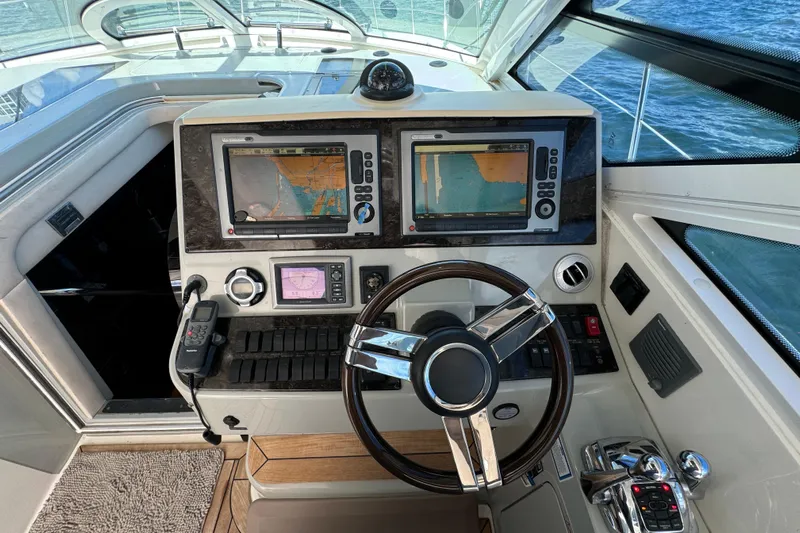 The Office Yacht Photos Pics Control panel of a 2011 Sea Ray 470 Sundancer yacht with navigation screens.