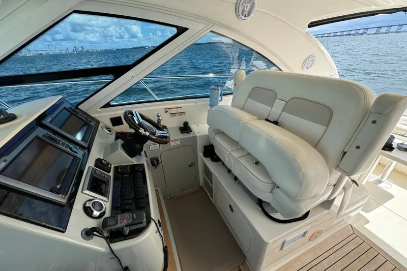 The Office Yacht Photos Pics 2011 Sea Ray 470 Sundancer helm with dual seats and navigation controls, overlooking ocean.