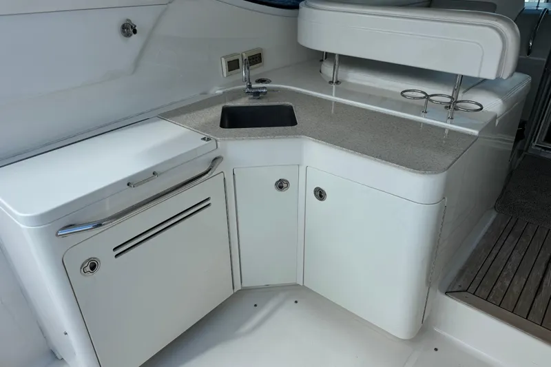 The Office Yacht Photos Pics 2011 Sea Ray 470 Sundancer yacht kitchenette with sink and storage cabinets.