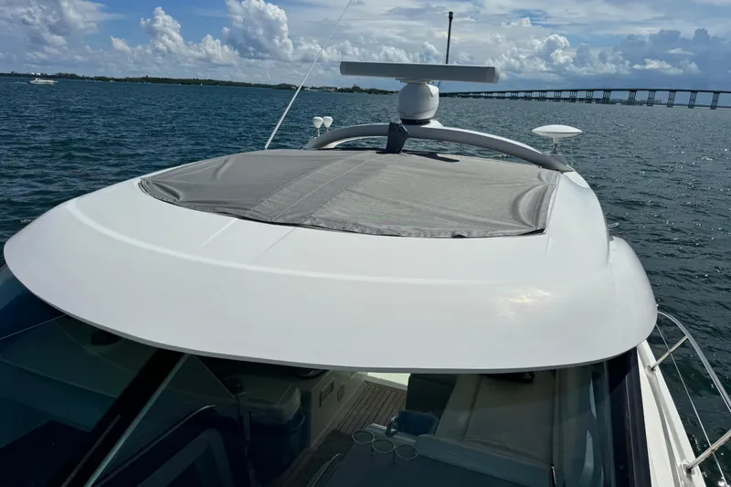 The Office Yacht Photos Pics 2011 Sea Ray 470 Sundancer yacht on water, bridge in background, sunny day.