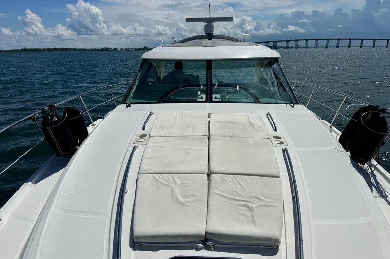 The Office Yacht Photos Pics 2011 Sea Ray 470 Sundancer yacht on open water with bridge in background.