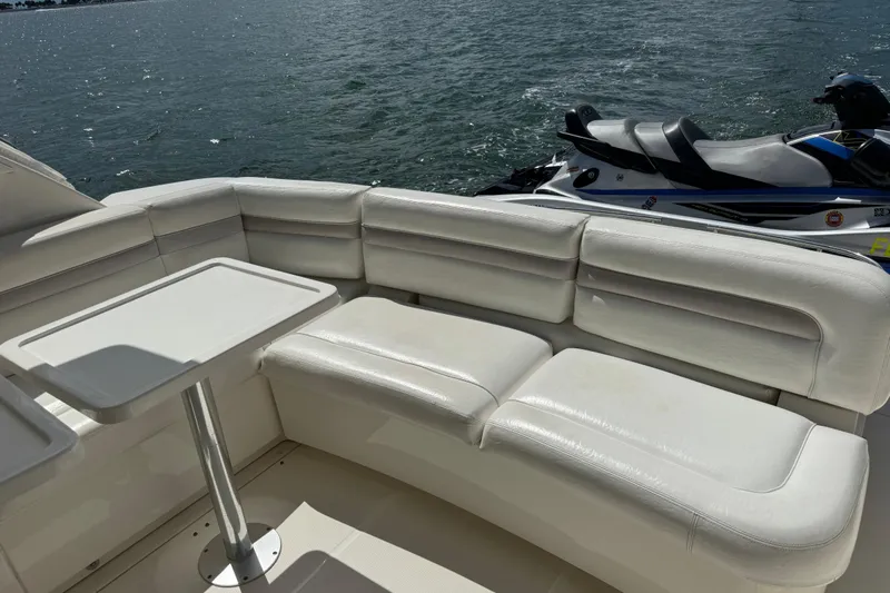 The Office Yacht Photos Pics Luxurious seating area on 2011 Sea Ray 470 Sundancer yacht with watercraft nearby.