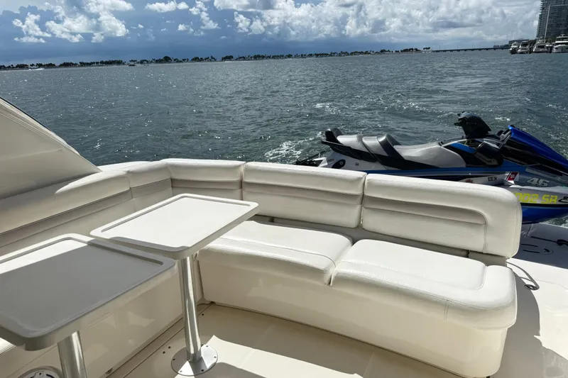 The Office Yacht Photos Pics Luxury seating on 2011 Sea Ray 470 Sundancer yacht with jet ski and ocean view.