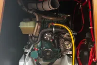 Engine compartment of a 2022 Dufour 32 sailboat, featuring hoses and belts.