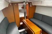 Interior of 2022 Dufour 32 yacht with modern wood finish and gray seating.