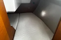 Interior cabin of 2022 Dufour 32 yacht with comfortable bedding.