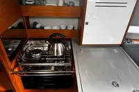 Modern galley kitchen in 2022 Dufour 32 yacht with stainless steel appliances.