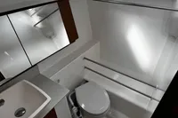 Modern bathroom interior of 2022 Dufour 32 yacht, featuring sink and toilet.