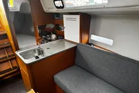 Interior of 2022 Dufour 32 sailboat with kitchenette and seating area.