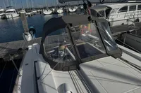 2022 Dufour 32 sailboat docked at a marina with protective canopy.