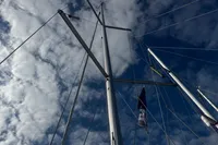 Mast and rigging of 2022 Dufour 32 sailboat against a cloudy sky.