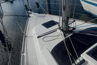 2022 Dufour 32 sailboat deck with rigging, docked in marina.