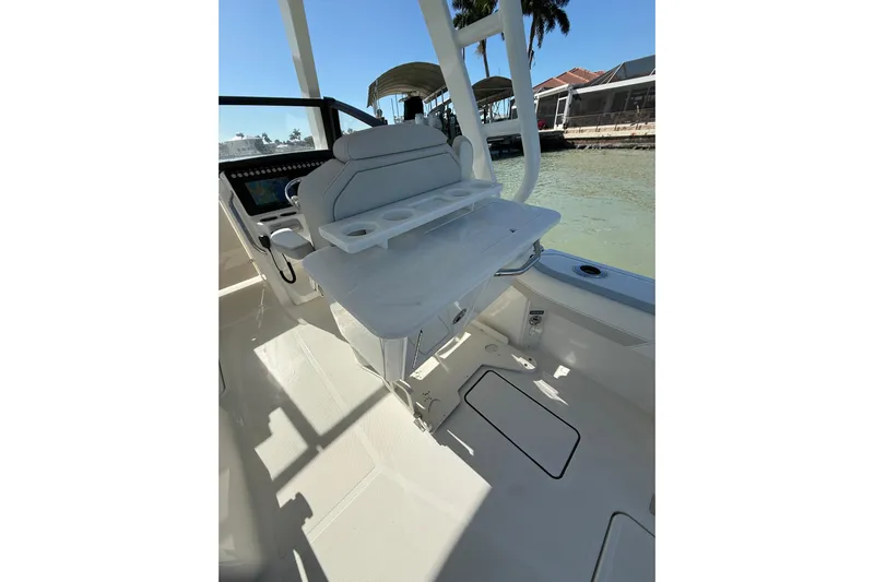  Yacht Photos Pics 2025 World Cat 260 DC-X boat interior with seating and cup holders, dockside view.