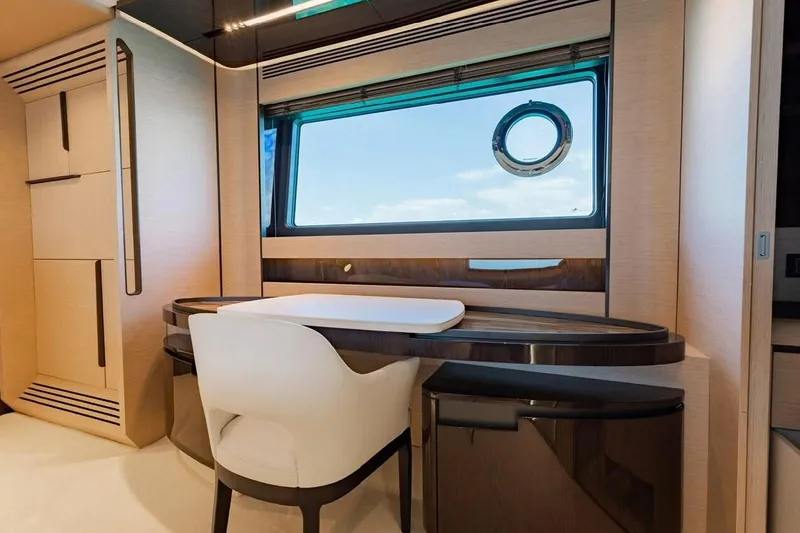 Lance West Yacht Photos Pics Luxurious interior of 2022 Azimut S10 yacht with elegant desk and chair by a window.