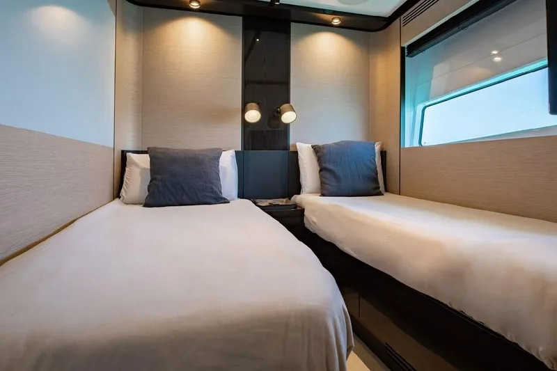 Lance West Yacht Photos Pics Luxurious twin cabin interior on 2022 Azimut S10 yacht, featuring modern design and cozy bedding.